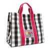 Angled front view of the Nodu Nadu Canvas Blair Bag in Black – highlighting pink handles, side panel with open slip pocket, and checkered embroidered patch with smiley face and nodu nadu stitch logo.