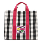 Nodu Nadu Canvas Blair Bag in Black – Stylish black and white checkered tote with bold pink handles, featuring a playful front patch design and durable canvas construction, perfect for everyday use or casual outings.