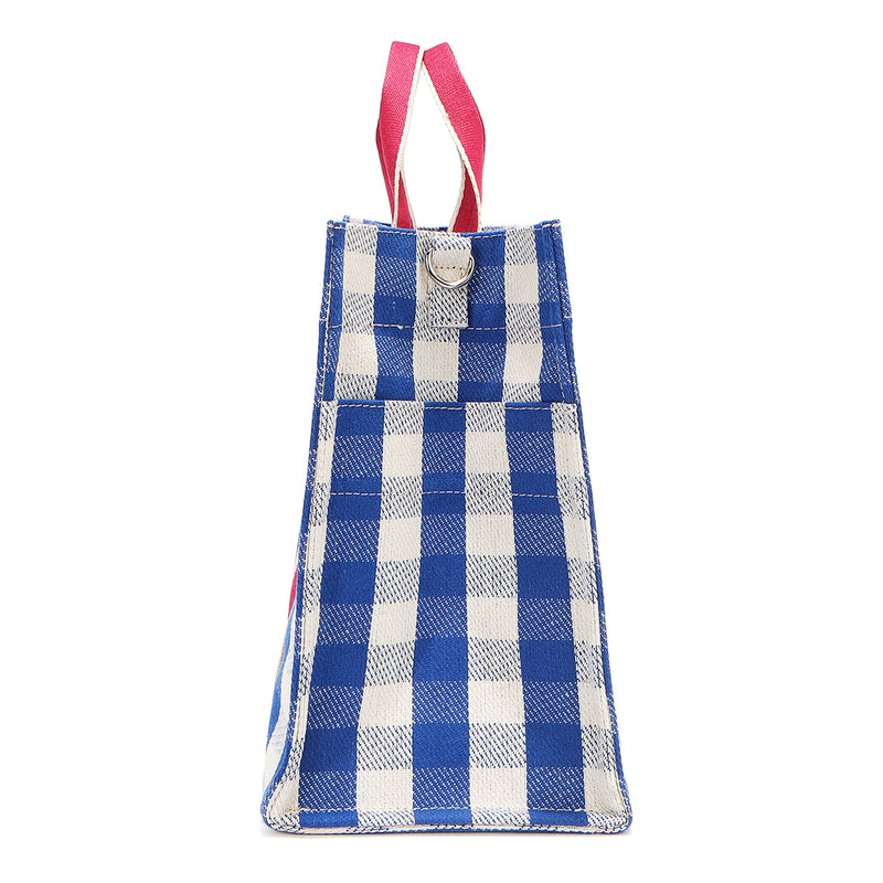 Rectangular and spacious side silhouette of the Nodu Nadu Blair Bag in Blue. Blue and white gingham print paired with hot pink dual straps. Side view shows the deep open slip pockets that you can store most-used items like your phone, keys, and makeup, close at hand! D-ring on the side for optional shoulder strap attachment.