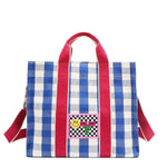 Your new go-to bag with a gingham twist! The Nodu Nadu Blair Bag in Blue brings a perfect mix of timeless charm and everyday durability, featuring a structured yet roomy silhouette, handy side pockets, and a back slip compartment to keep your essentials effortlessly organized. Pictured with the optional, adjustable shoulder strap attached for varied carrying options and versatility when wearing. 