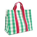 Back angle view of the Nodu Nadu Canvas Blair Bag in Green – simple green and white gingham design with hot pink vertical webbed straps. Side back angle view showcases the open slip pocket on the side and the rectangular silhouette.
