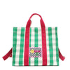 Green and white checkered Nodu Nadu Blair Bag front adorned with a checker print stitched logo with Nodu Nadu smiley face. Grass green paired with classic white and accented with pops of hot pink. Pictured with its adjustable, detachable tonal hot pink shoulder strap to showcase varied carrying options and versatility when styling and wearing.