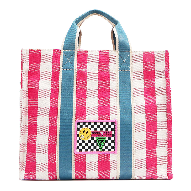 Your new go-to bag with a gingham twist! The Nodu Nadu Blair Canvas Bag in pink brings a perfect mix of timeless charm and everyday durability, featuring a structured yet roomy silhouette, handy side pockets, and a back slip compartment to keep your essentials effortlessly organized. Made of durable canvas and designed in Los Angeles, California. Bold pink paired with sky blue straps make for a sweet and feminine look!