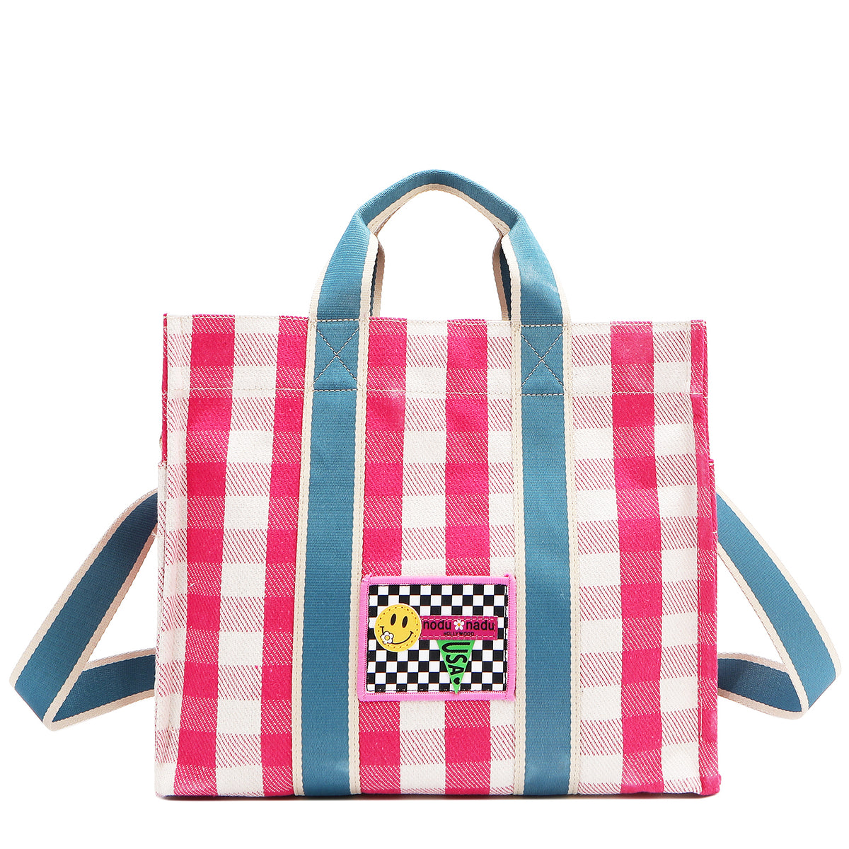 Your new go-to bag with a gingham twist! The Nodu Nadu Blair Canvas Bag in pink brings a perfect mix of timeless charm and everyday durability, featuring a structured yet roomy silhouette, handy side pockets, and a back slip compartment to keep your essentials effortlessly organized. Made of durable canvas and designed in Los Angeles, California. Bold pink paired with sky blue straps make for a sweet and feminine look! Optional, adjustable and detachable tonal blue shoulder strap provides versatility. 