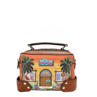 Our Sun and Sand Crossbody with tropical design featuring palm trees and a beach hut set on a white background.