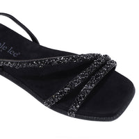 A CLOSER LOOK ON OUR DANI SANDAL. RHINESTONE ENCRUSTED CRISSCROSS STRAPS AND A MODERN SQUARE TOE.