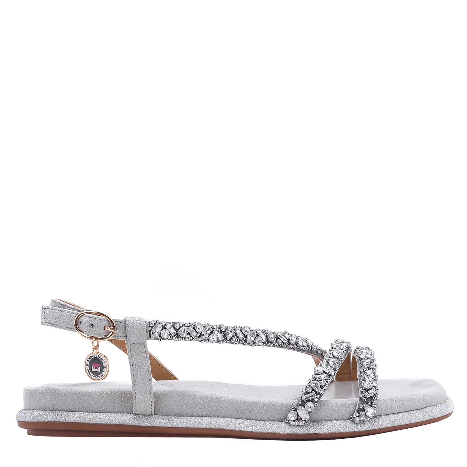 OUR DANI RHINESTONE SANDAL IN SILVER EMBELLISHED WITH A ADJUSTABLE BUCKLE CLOSURE WITH A NICOLE LEE CHARM FOR STATEMENT. SUEDE UPPER AND INSOLE. OPEN TOE AND RUBBER OUTSOLE