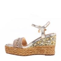 Kali Espadrille Wedge sandal in gold.  Fitted with 1 adjustable buckle. The buckle has a small Nicole Lee Charm.The wedge is adorned with rhinestones and  braid detailing.