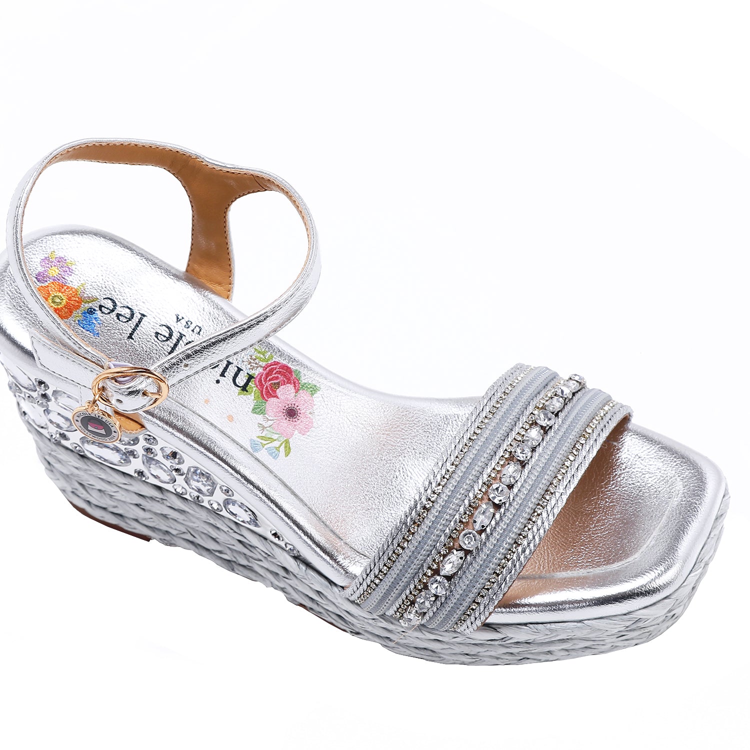 Kali Espadrille Wedge sandal in Silver.  Fitted with 1 adjustable buckle. .The insole is gold with the Nicole Lee logo. Top strap is embellished with rhinestones.