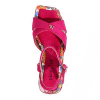 THE SANDAL FROM A VIEW FROM ABOVE. THE CRISSCROSS STRAPS WITH THE NL INITIALS IN THE MIDDLE. THE HOTPINK INSOLE WITH FLORAL PRINT ON THE EDGES.