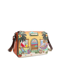 Our Sun and Sand Crossbody bag with a tropical design featuring a beach hut, palm trees, and beach items set on a white background.
